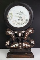 Chinese pierced hardwood table screen, the circular enamel panel hand decorated with a mountainous