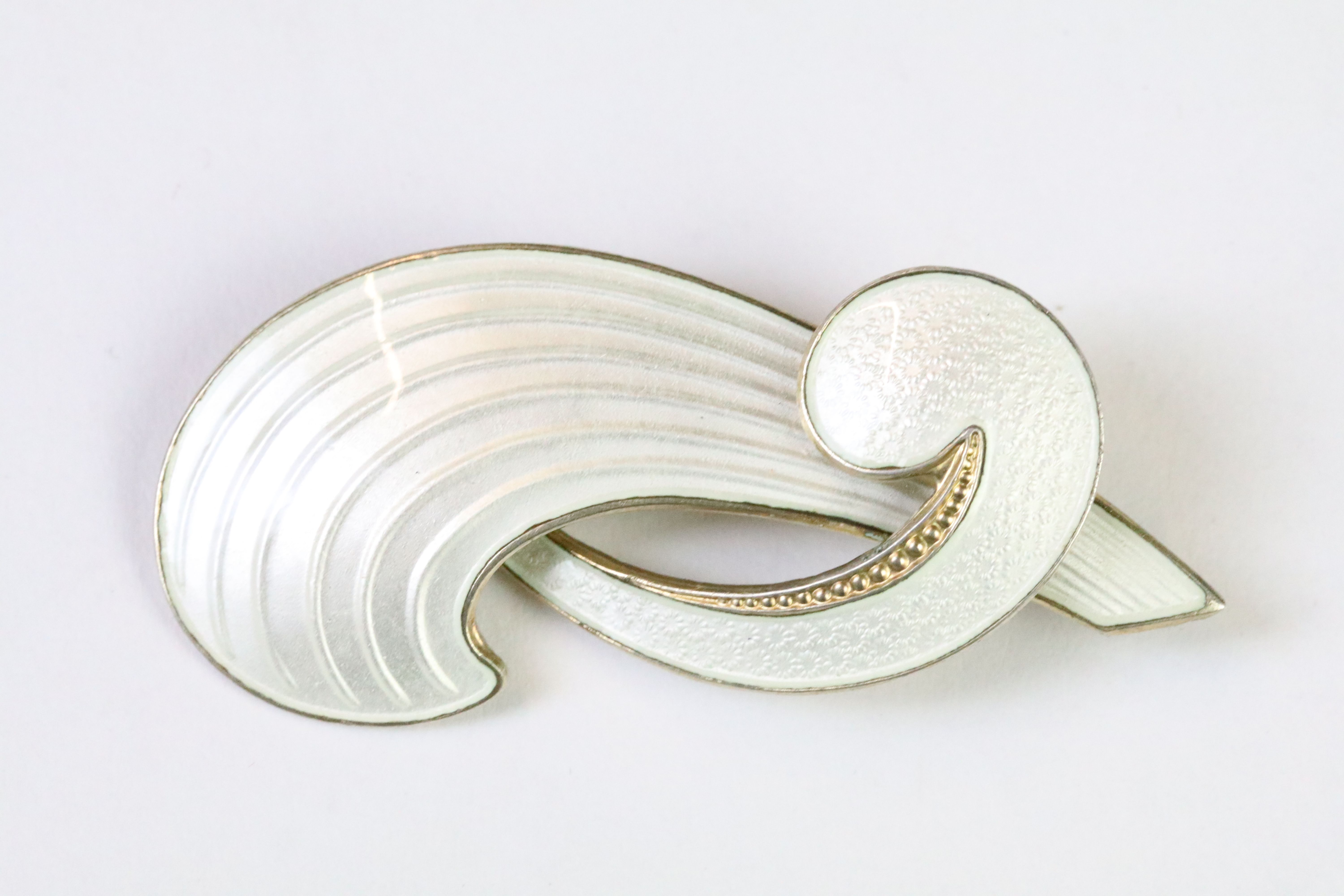 A mid 20th century Norwegian sterling silver and white enamel brooch by Albert Scharning, marked