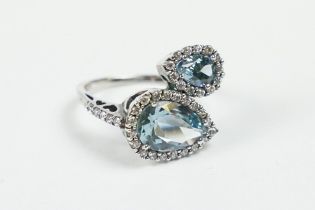 A contemporary 925 sterling silver ladies dress ring set with two large light blue stones of