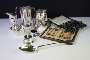 A small collection of mixed silver plated to include cased spoon sets, tankards, serving spoon....