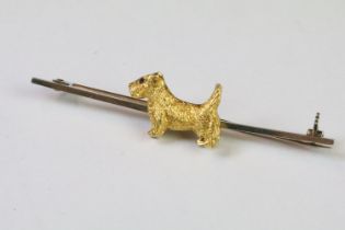 A 9ct gold Scottie dog bar brooch with rose gold pin, marked 9ct with a maker mark A&W .
