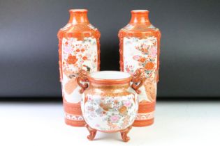 Pair of Japanese Kutani vases being hand decorated with perched birds, together with a matching twin