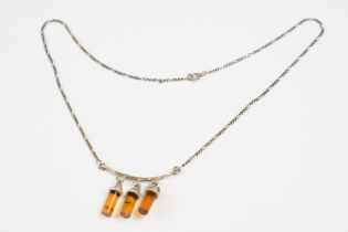 A contemporary 925 sterling silver necklace with three amber style hanging drops on Figaro chain,