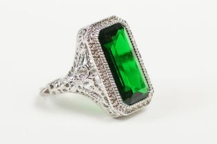 A 925 sterling silver ladies dress ring of classical style with green centre stone raised to