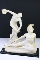 Two cast resin classical style sculpture figurines to include a discus thrower and a recumbent