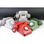 Group of four late 20th Century ring dial plastic telephones in assorted colours.