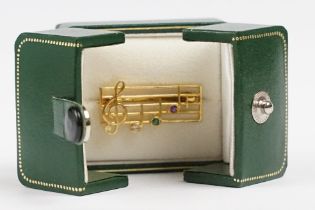 A ladies hallmarked 9ct gold brooch in the form of musical notes.