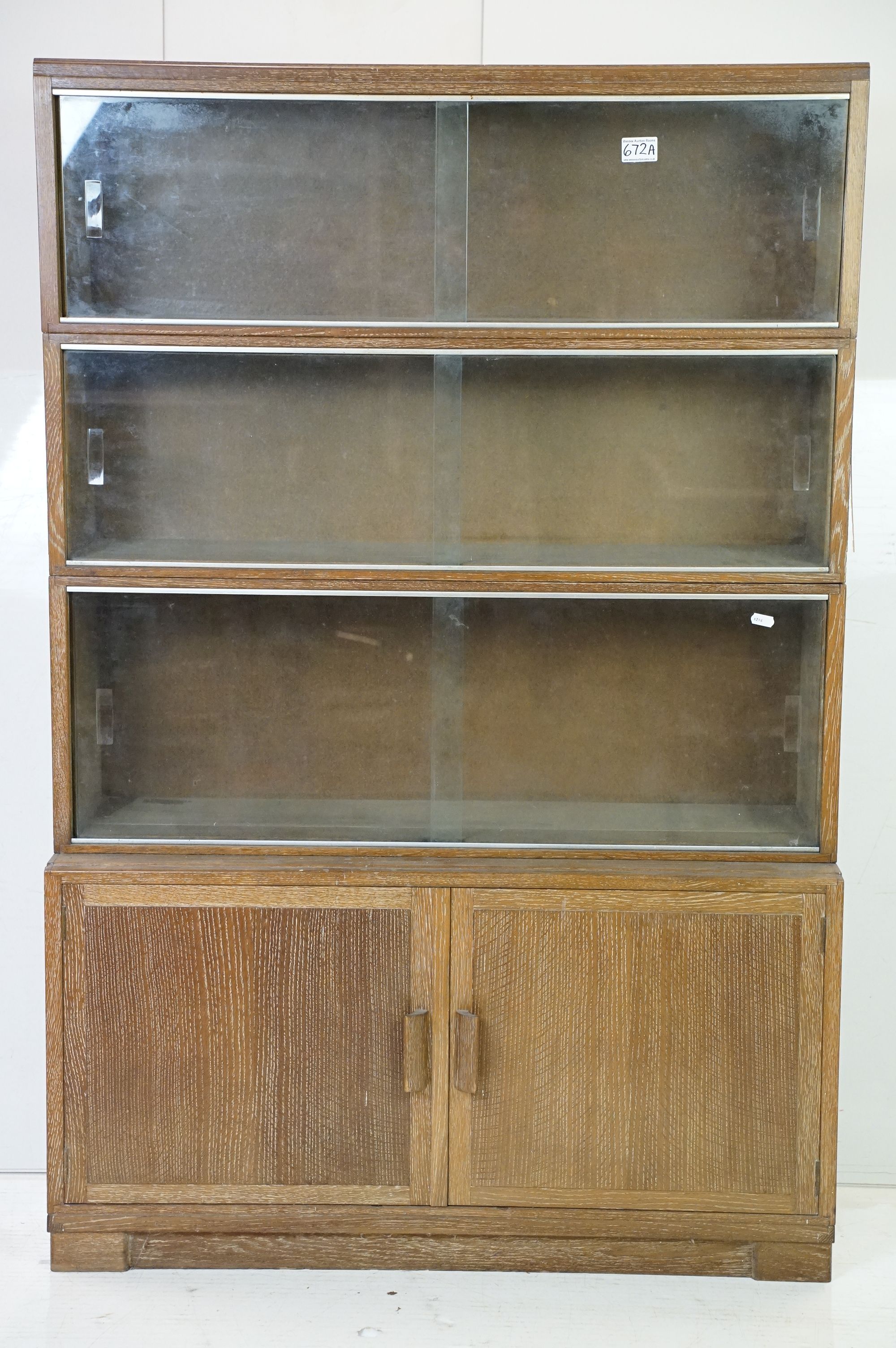 Mid century Oak Four Section Modular Stacking Bookcase, the upper three sections with glass