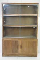 Mid century Oak Four Section Modular Stacking Bookcase, the upper three sections with glass