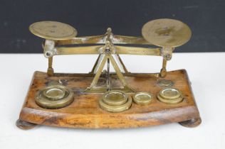 Pair of early 20th Century small desk top balance scales having seven brass oz weights, raised on