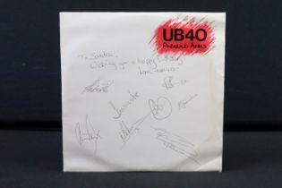 Memorabilia & Autographs - UB40 Present Arms LP clearly signed to front cover by eight band members.