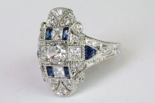 A 925 sterling silver ladies dress ring in the Art Deco style set with blue and clear stones, marked