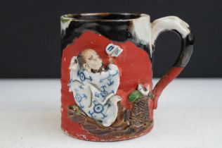 Japanese Sumida Gawa pottery mug / tankard, with relief decoration of a figure, signed Ryosai,