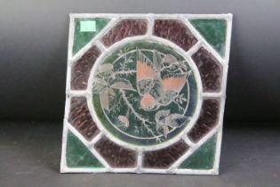 Victorian stained glass window panel featuring a bird with foliate detailing to centre, having green