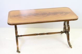 20th century mahogany coffee table with lyre end supports, on brass lion paw feet with brass