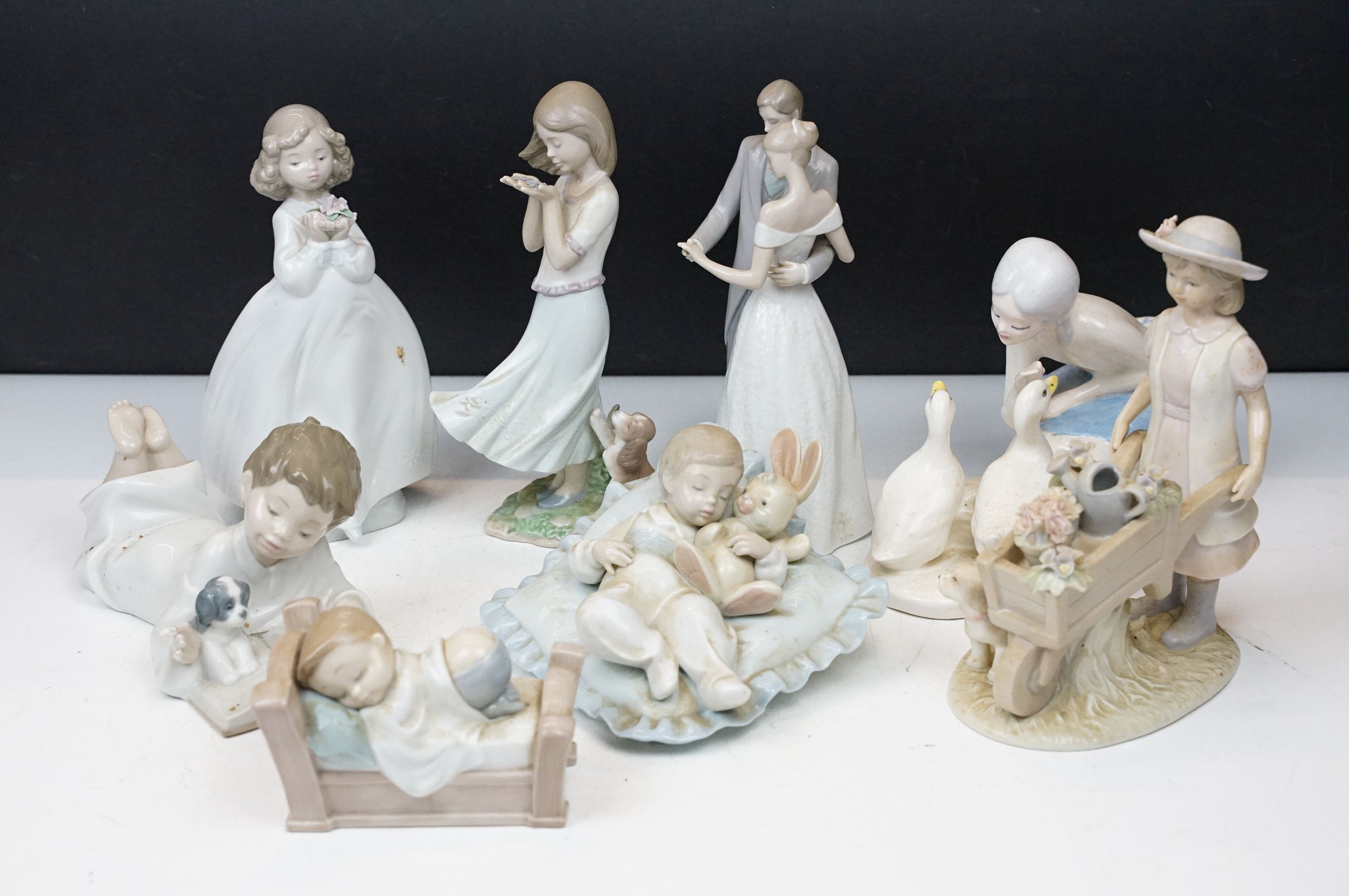 Collection of porcelain figures to include Lladro (6791 Taking a Snooze, 8121 Whispering Breeze,