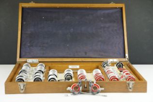 A vintage British made opticians eye testing set of lenses with spectacles.