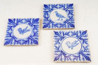 Three blue & white tiles with central panels depicting birds, bordered by foliate detail, measure