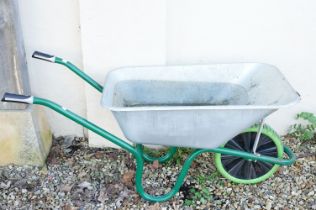 Contemporary metal wheel barrow, measures approx 137cm long