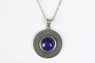 A 925 sterling silver pendant set with central lapis lazuli cabochon, marked 925 to the verso and