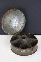 Indian metal spice box of cylindrical form, opening to a compartmented interior, with brass carry