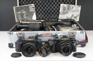 A collection of Canon photographic equipment to include two Canon T70 SLR cameras, lenses,