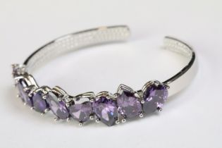 A 925 sterling silver and amethyst open bangle bracelet, set with nine teardrop amethyst, marked 925