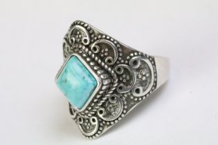 A 925 sterling silver and turquoise ladies ring, decorative scroll pattern surrounding central