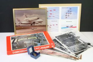 A small group of aviation collectables to include Concorde tie pin, framed space shuttle photograph,