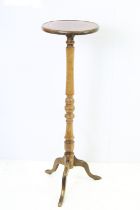 20th century hardwood torchere, the circular top inlaid with two concentric circles, above turned