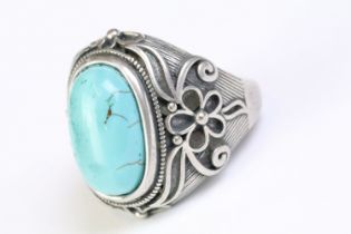 A 925 Sterling silver with turquoise cabochon to centre ladies ring with decorative floral