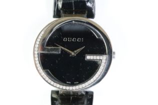 Ladies Gucci diamond bezel wristwatch on black leather strap, complete with display box.