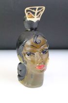 An mid 20th century bottle in the form of a female head complete with contents.