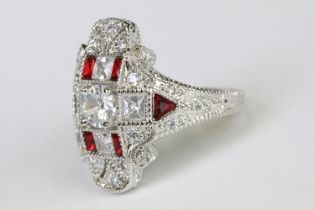 A 925 sterling silver ladies dress ring in the Art Deco style set with red and clear stones,