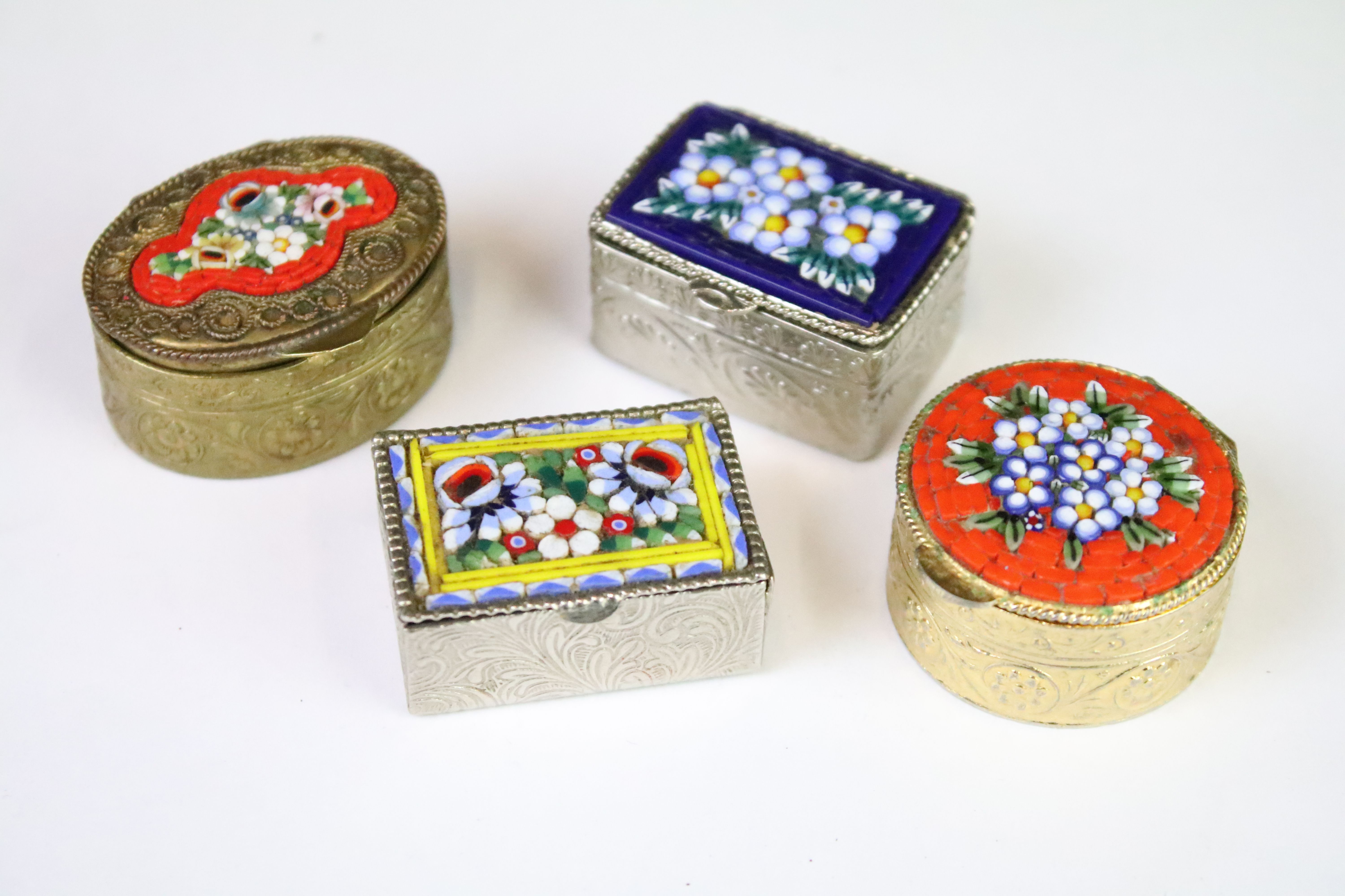 A collection of four vintage micro mosaic pill boxes to include three marked Italy.