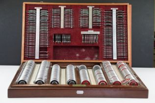 A vintage opticians eye testing kits within wooden cases.