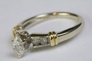 14ct yellow gold ring with central marquoise and brilliant cut diamond shoulders