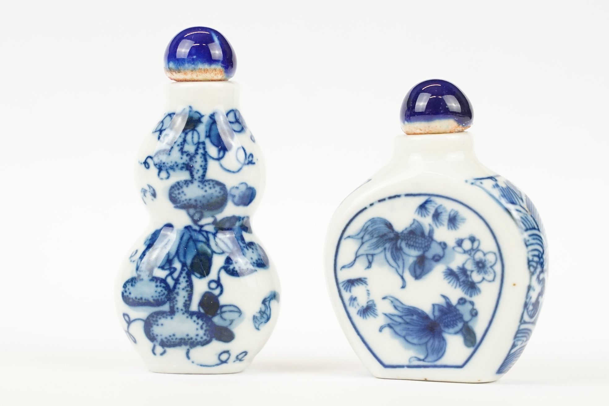 Two Chinese blue and white ceramic snuff bottles with traditional Chinese decoration.