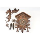 A vintage German cuckoo clock complete with weights.