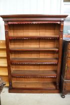 Mahogany bookcase of five shelves, with cut leather gilt embossed fringes, 180cm high x 135cm wide x