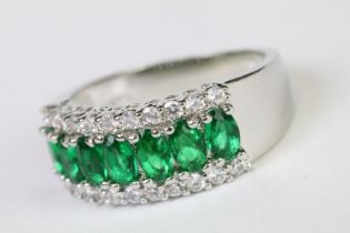 A 925 sterling silver ladies dress ring in the Art Deco style set with green and clear stones,