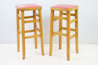 Pair of vintage kitchen high stools, with red leatherette padded seats, each 72.5cm high x 33cm wide