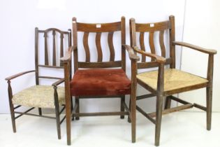 Pair of oak elbow chairs, one with rush seat and another with a corduroy seat, 96cm high x 60cm wide