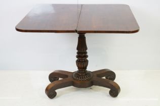 William IV rosewood games table, top swivels to reveal enclosure, on turned fluted support and