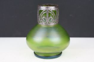 Art Nouveau green iridescent glass vase, of squat baluster form, with pierced white metal mount to