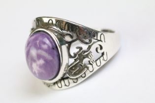 A 925 sterling silver ladies ring with purple cabochon central stone with decorative shoulder