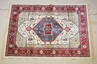 Ivory ground Kashmir floor rug with Aztec medallion design, approx 180cm long x 116cm wide