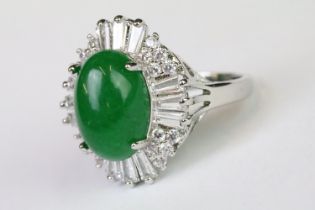 A 925 sterling silver ladies dress ring of classical style with oval green centre stone with clear
