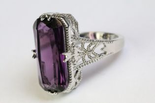 A 925 sterling silver and amethyst ladies traditional dress ring, set with large central amethyst,