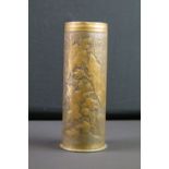 A World War One trench art vase decorated with floral pattern formed from a brass artillery shell,